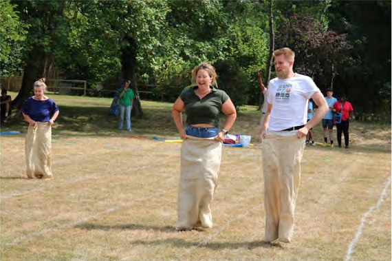 Staff taking part in the sack race on the school field
